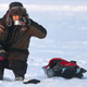 Ice fisherman drinking coffee on ice
